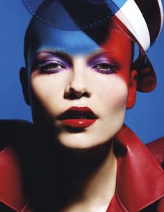 a woman with red, white and blue makeup