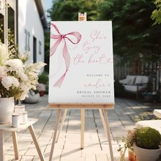 an easel with a sign that says welcome to the bride