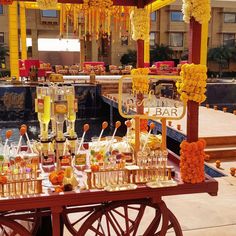 an outdoor bar set up with flowers and drinks