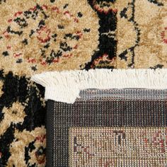 an area rug that has been cleaned and is laying on top of the carpet with a brush