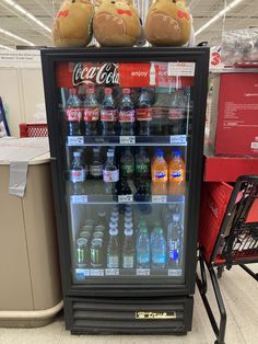 a vending machine with two stuffed animals sitting on top of it in a store