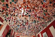 a room filled with lots of different colored ornaments hanging from the ceiling and on the walls