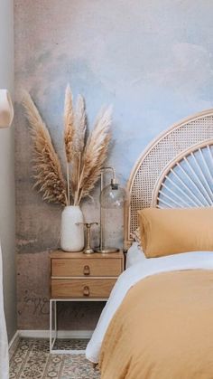 a bedroom with a wicker headboard and tan bedding