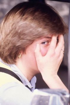 a woman sitting in a car with her hand on her face