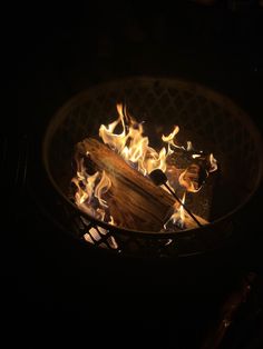 a fire pit with flames burning in the dark