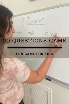 a woman writing on a white board with the words 20 questions game