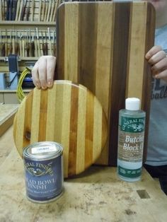 a man is working on a cutting board with some paint and wood shaving tools