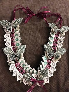 a necklace made out of dollar bills and ribbons