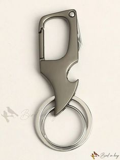 a bottle opener with a metal ring attached to it's side on a white surface