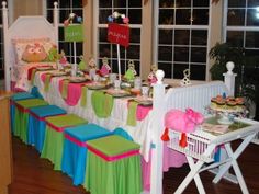 a table set up for a tea party with lots of food and decorations on it