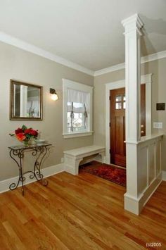 a room with wood floors and white trim