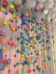 colorful stars and balls hanging from the ceiling