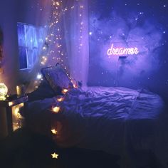 a bedroom with lights on the walls and a bed