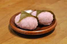 some food is sitting on a wooden plate