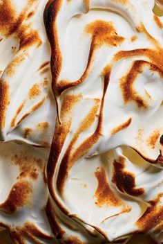 a pie with white frosting and brown swirls