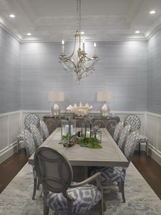 a dining room table with chairs and a chandelier