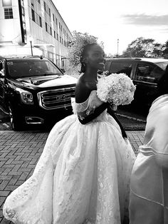 a woman in a wedding dress walking down the street