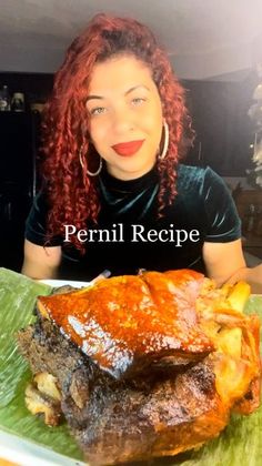 a woman sitting at a table in front of a plate of food with meat on it