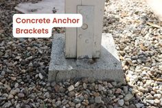 a concrete block with the words concrete anchor brackets on it in front of some rocks