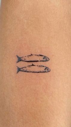 two fish on the back of a woman's thigh