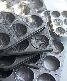 several muffin tins are stacked on top of each other with holes in them