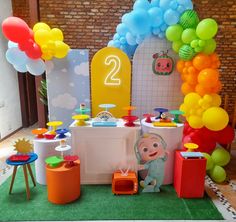 a birthday party with balloons and decorations on the floor, including an ice cream stand