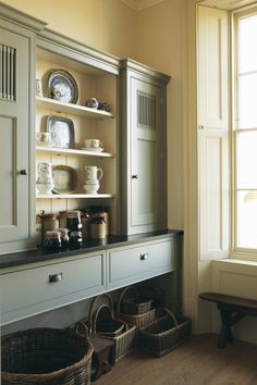 an old china cabinet with dishes on it