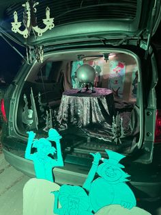 the back end of a car that has been decorated with blue paper cutouts and decorations