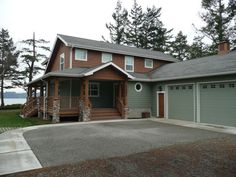 a large house with two garages in front of it