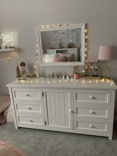 a white dresser with christmas lights on it