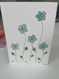 a white card with blue flowers on it