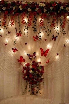 the curtains are decorated with flowers and butterflies on them, along with lights in the background