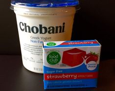 a yogurt container next to a carton of ice cream on a table