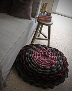 a living room with a couch, coffee table and rugs on the floor in front of it