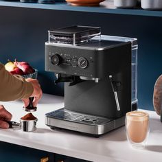 a coffee maker is being used to make espresso