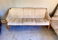 two couches sitting next to each other in a room with carpeted flooring