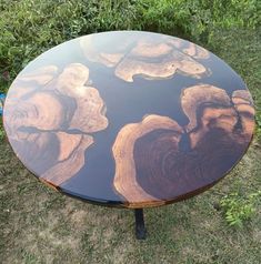 a table that has been made out of wood and is sitting in the grass outside