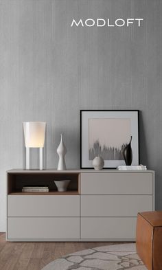 the modern sideboard has two vases on it and is next to a lamp