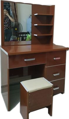 a dressing table with a mirror and stool