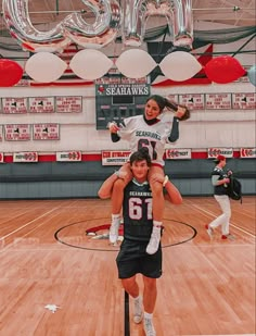 two people are doing tricks on a basketball court