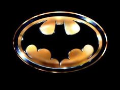 the batman symbol is shown in gold and black