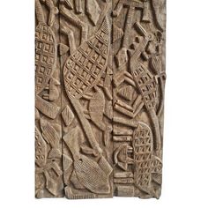 an intricately carved wall panel with people and buildings