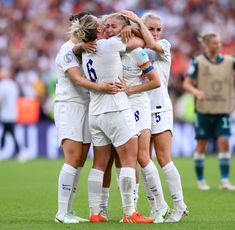 the women's soccer team is hugging each other