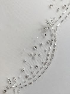 a white dress with crystal beads on it