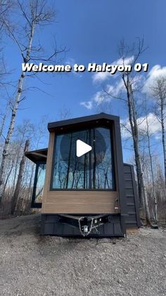 a tiny house sitting in the middle of a forest