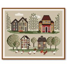 two cross stitch houses with chickens and trees in the foreground, one is red