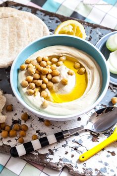 hummus and pita bread on a table with an assortment of ingredients including olives