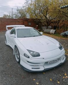 a white sports car parked in a parking lot