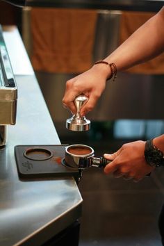 a person is pouring coffee into a cup