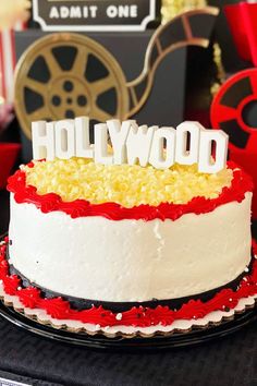 a hollywood themed birthday cake with red and white frosting